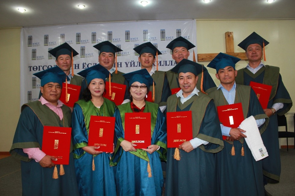 Church Leaders - newly graduated - standing in cap and gown